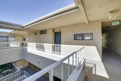 a balcony of a building with a stair case at 1 Mi to the Ocean Long Beach Condo with Pool Access in Long Beach