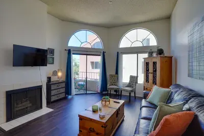 a living room with a couch and a fireplace at 1 Mi to the Ocean Long Beach Condo with Pool Access in Long Beach