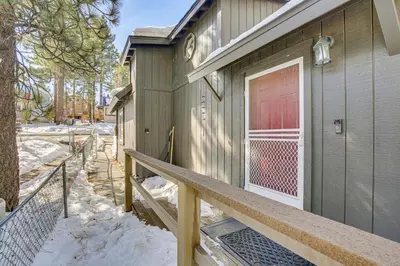 a front door of a house with a red door at Cozy Cabin with Deck - 2 Mi to Bear Mountain Resort! in Big Bear Lake