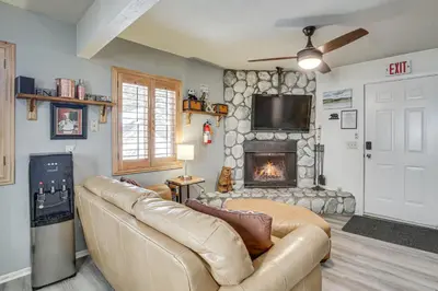 a living room with a couch and a fireplace at Cozy Cabin with Deck - 2 Mi to Bear Mountain Resort! in Big Bear Lake