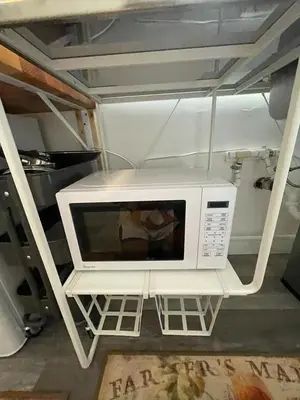 a microwave sitting on a shelf in a room at Petite Guesthouse with Kitchenette and Private Bathroom in Lake Isabella