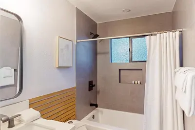 a bathroom with a shower and a sink and a toilet at The Snow White in Lake Arrowhead