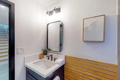 a bathroom with a sink and a mirror at The Snow White in Lake Arrowhead