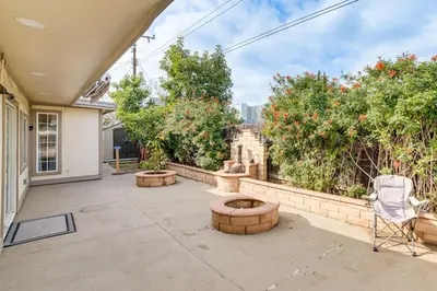 a patio with a chair and trees and bushes at Family-Friendly Loma Linda Retreat Walk to LLU in Loma Linda