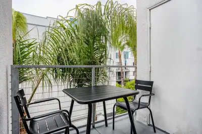 a black table and chairs on a balcony with plants at Playa Vista 1br w gym pool table nr beach LAX-1123 in Los Angeles