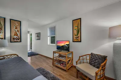 a bedroom with a bed and a tv and a chair at Secret Stairs Studio #1 in Los Angeles
