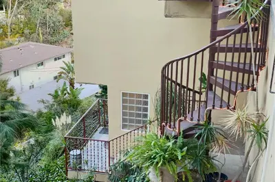 an apartment balcony with stairs and plants at Secret Stairs Studio #1 in Los Angeles