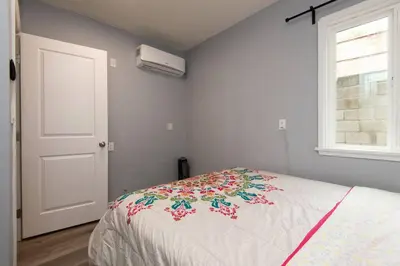 a bedroom with a bed with a flower blanket on it at Lovely 3bedroom condo with free parking on premise in Los Angeles