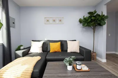 a black leather couch in a living room at Lovely 3bedroom condo with free parking on premise in Los Angeles