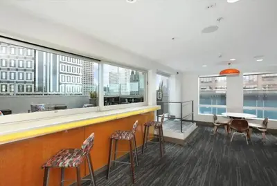 a bar with chairs and a table in a building at Comfy Cozy Apt with pool & hot tub in downtown LA' in Los Angeles