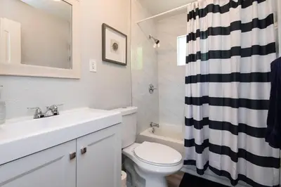a bathroom with a sink and a toilet and a shower curtain at Lovely 2bedroom condo with free parking on premise in Los Angeles