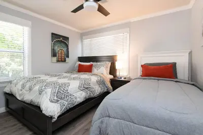 a bedroom with two beds and a ceiling fan at Lovely 2bedroom condo with free parking on premise in Los Angeles