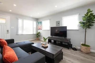 a living room with a couch and a flat screen tv at Lovely 2bedroom condo with free parking on premise in Los Angeles
