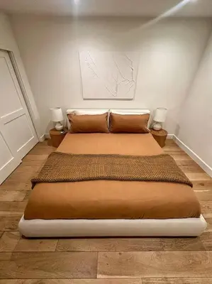 a bedroom with a large bed with two night stands at Luxury 1BR Malibu Bungalow on PCH + steps from Beach! in Malibu