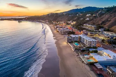 an aerial view of a beach at sunset at Luxury 1BR Malibu Bungalow on PCH + steps from Beach! in Malibu