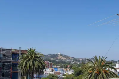 a view of a city with palm trees and buildings at Hollywood 2Bed Apt w Rooftop pool & Panoramic View in Los Angeles