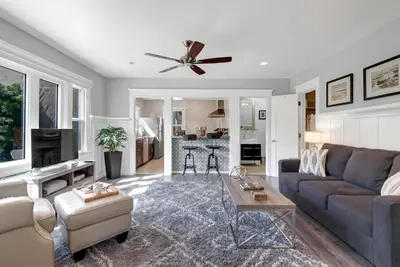 a living room with a couch and a table at East Village Apartments in Long Beach
