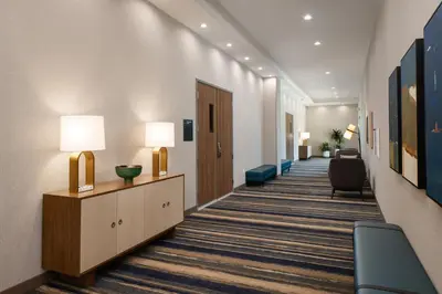 a hallway of a hotel room with a waiting room at Holiday Inn & Suites Monterey Park – Los Angeles by IHG in Monterey Park