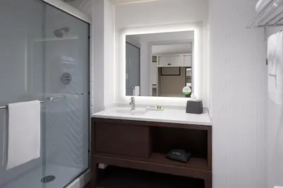 a bathroom with a sink and a mirror at Holiday Inn & Suites Monterey Park – Los Angeles by IHG in Monterey Park
