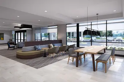 a living room with a couch and a table and chairs at Holiday Inn & Suites Monterey Park – Los Angeles by IHG in Monterey Park