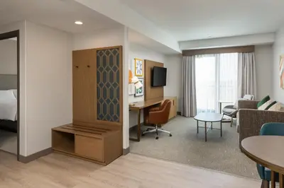 a hotel room with a bed and a desk in a room at Holiday Inn & Suites Monterey Park – Los Angeles by IHG in Monterey Park
