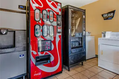 a coca cola vending machine next to a refrigerator at Hotel Europa Ridgecrest in Ridgecrest