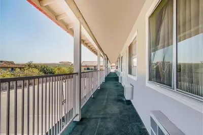 an empty balcony of a building with windows at Hotel Europa Ridgecrest in Ridgecrest