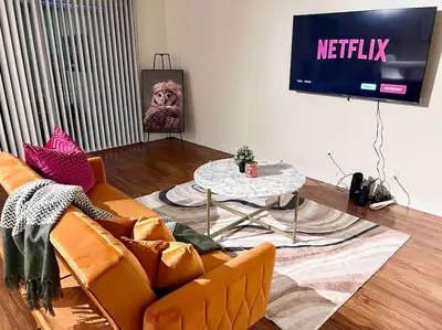 a living room with a couch and a tv at Ocean 2 min, free pool & parking in Los Angeles