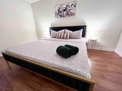 a bed with a green pillow on top of it at Ocean 2 min, free pool & parking in Los Angeles