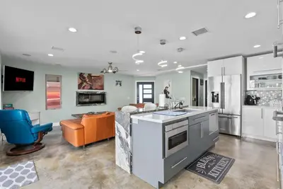 a kitchen with an island and a couch in a room at Voted Airbnb Most Loved Home 2024 Duffy Boat in Huntington Beach
