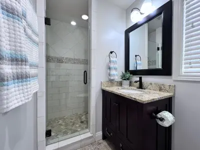 a bathroom with a shower and a sink and a mirror at Destination #02 in Anaheim
