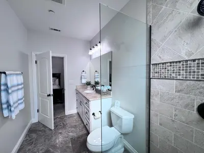 a bathroom with a toilet and a glass shower at Destination #02 in Anaheim