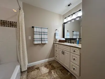 a bathroom with a tub and a sink and a mirror at Destination #23 in Anaheim