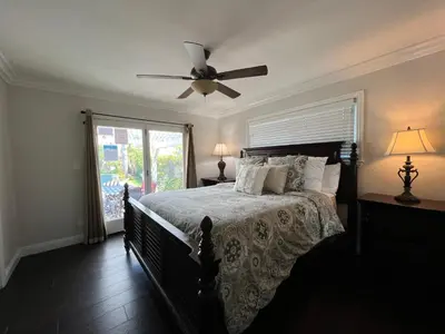 a bedroom with a bed with a ceiling fan at Destination #23 in Anaheim