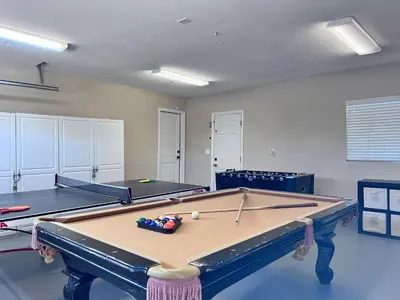 a pool table in a room with two tables at Destination #08 in Anaheim
