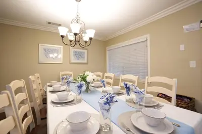 a dining room with a white table and chairs at Destination #08 in Anaheim