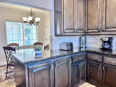 a kitchen with wooden cabinets and a counter top at Destination #12 in Anaheim