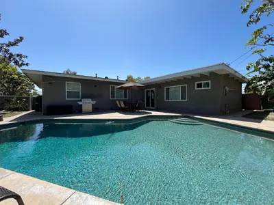 a swimming pool in front of a house at Destination #12 in Anaheim