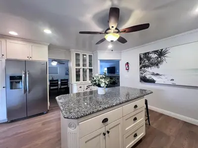 a kitchen with a ceiling fan and a refrigerator at Destination #13 in Anaheim