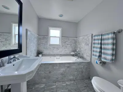 a bathroom with a tub and a sink and a toilet at Destination #13 in Anaheim