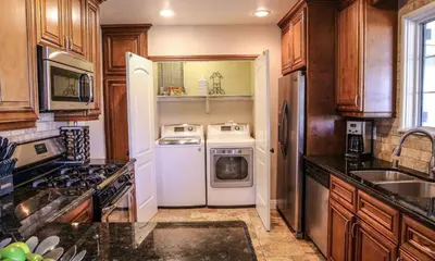 a kitchen with a white refrigerator and a dishwasher at Destination #19 in Anaheim