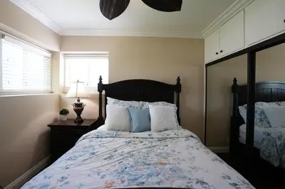 a bedroom with a bed with blue and white pillows at Destination #19 in Anaheim