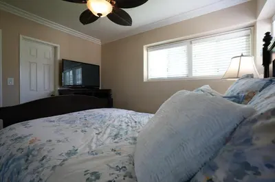 a bedroom with a bed and a ceiling fan at Destination #19 in Anaheim