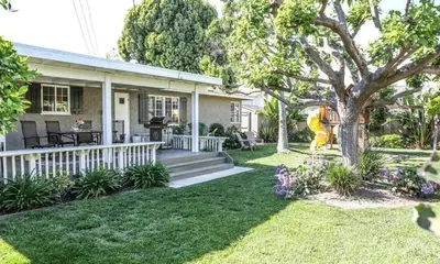 a house with a porch and a yard at Destination #19 in Anaheim