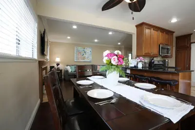 a dining room table with plates and a vase of flowers at Destination #19 in Anaheim