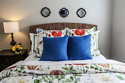 a bedroom with a bed with blue pillows at Destination #37 in Fullerton