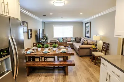 a kitchen and living room with a table and refrigerator at Destination #37 in Fullerton