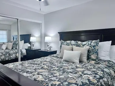 a bedroom with a large bed with a large mirror at Destination #09 in Anaheim