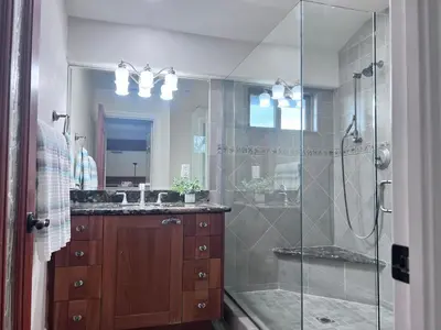 a bathroom with a glass shower and a sink at Destination #09 in Anaheim
