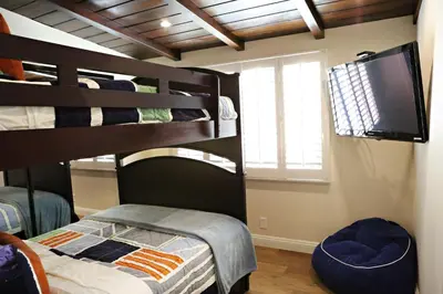 a bedroom with a bunk bed and a television at Destination #21 in Anaheim